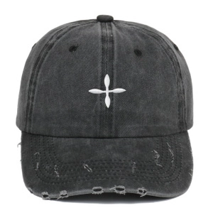 Detailed view of white star embroidery and distressed frayed edges on washed cotton cap
