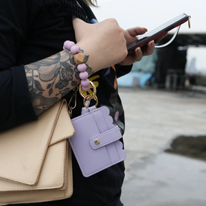 Close-up of lavender PU leather card holder with purple silicone bead wristlet keychain