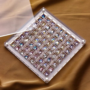 Transparent acrylic nail art organizer box with colorful crystal rhinestones on brown silk
