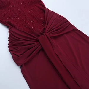 Detail of burgundy evening gown with silver sequins and a large decorative bow at the waist