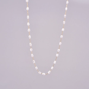 Close-up of baroque freshwater pearl and 18K gold-plated stainless steel chain detail
