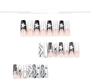 Macro view of long coffin press-on nails with star patterns, fire art, and rhinestones