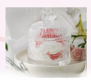 Exquisite crown-lidded relief glass jar with decorative peach blossom scented candle inside