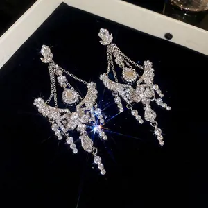 Sparkling silver drop earrings with floral rhinestones and long tassel fringe details