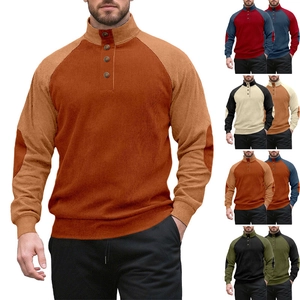 Detail view of men's color-block knit henley sweater featuring a stand collar and button neck