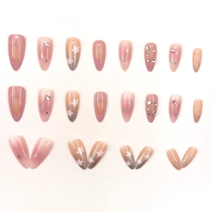Pink gradient press-on nails with silver stars and rhinestones in long stiletto shape