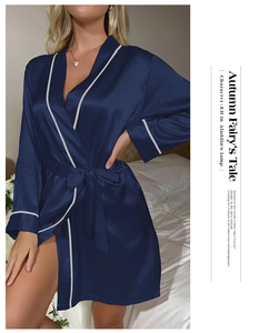 Detailed view of luxury navy blue silk bathrobe with elegant white piping and sash tie
