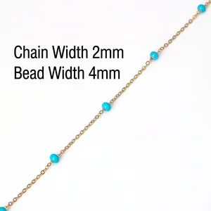 Macro detail of 2mm gold chain with 4mm blue beads for DIY jewelry making