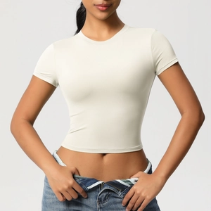 Close-up of beige slim-fit crop top showing smooth elastic fabric and crew neckline