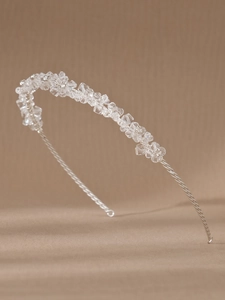 Detailed view of silver wire floral design with clear crystal beads on a bridal headband