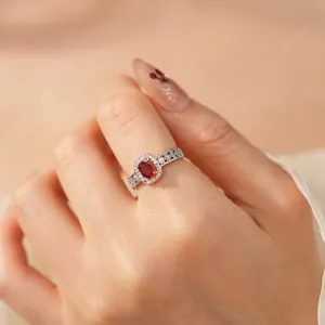 Elegant silver-toned open ring with oval red ruby and sparkling zircon halo