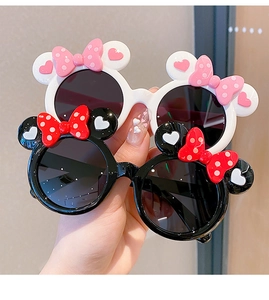Close-up of cute cartoon mouse ear sunglasses with polka dot bows for little girls