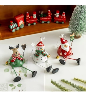 Detailed view of metal Christmas hanging ornaments featuring Santa, Snowman and Reindeer figurines