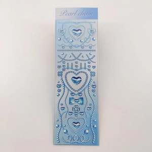 Detail of DIY pearl chain stickers with blue gradient hearts and shiny Y2K bow design