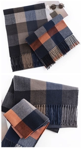 Detailed close-up of checkerboard cashmere scarf featuring classic fringe and soft texture