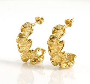 Macro shot of 18K gold titanium steel C-hoop earrings with unique ripple texture detail