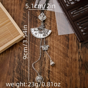 Detailed silver fan-shaped brooch with butterfly and bell charms including size specs