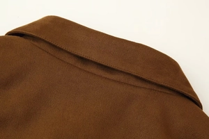 Close-up of brown wool-texture jacket with high-quality lapel and metal zipper detail