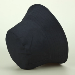 Detailed close-up of a black bucket hat showing reinforced stitching on the cotton brim