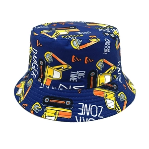 Detail of kids bucket hat with navy blue cotton fabric and yellow excavator prints