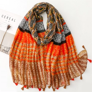 Ethnic bohemian scarf with orange and black geometric patterns and fringe tassels