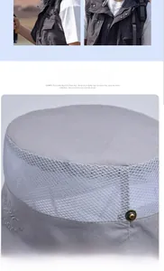 Detail view of the breathable mesh crown and sport embroidery on the grey hiking sun hat