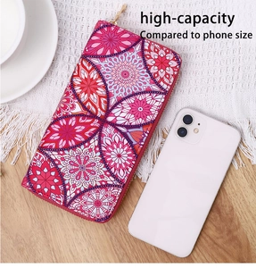 Ethnic mandala patterned long wallet showing high-capacity scale compared to a smartphone