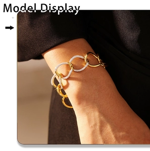 Detail of gold chain bracelet featuring interlocking links with pave-set zircon stones