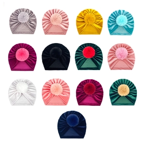 Baby velvet beanie with pompom available in 13 colors for infants and toddlers