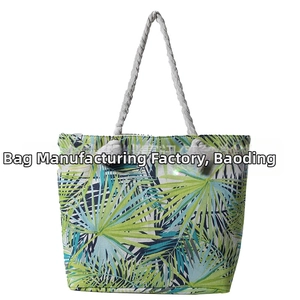 Detail of canvas tote bag with tropical palm leaf pattern and thick rope handles