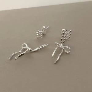 Detail shot of a minimalist 925 sterling silver bow earring with S925 hallmark stamp