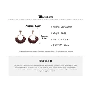 Detailed view of retro dark red leather wrapped round earrings with silver pins