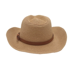 Close-up of fine hand-woven raffia texture and brown leather band on the Panama sun hat