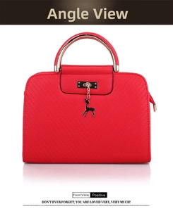 Front view detail of red embossed PU leather handbag with gold metal handle and deer charm