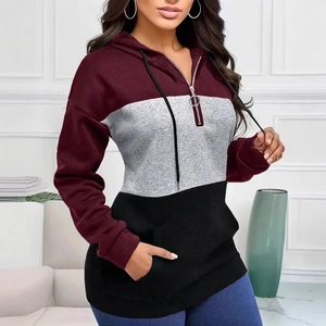 Detail of color-block hoodie featuring burgundy, grey, black panels and metal zipper