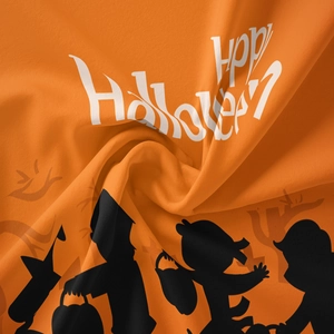 Close-up of Happy Halloween print on orange fabric with soft texture and spiral folding