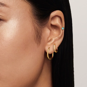 Three-piece stainless steel earring set with gold finish, zircons, and blue gemstone