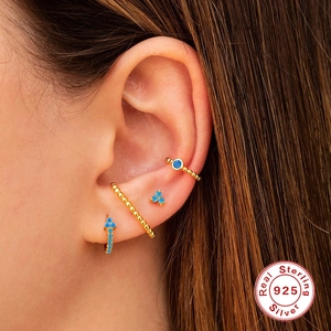 Three-piece 925 sterling silver earring set in gold finish with turquoise stones