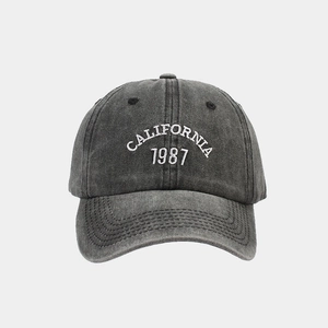 Detailed view of California 1987 embroidery on washed dark grey cotton baseball cap