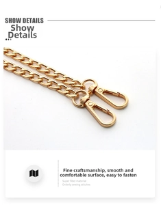 Detail showing polished gold metal chain strap with rotatable lobster clasps for bags