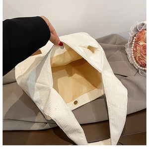 Detail view of corduroy tote bag interior with magnetic closure and fabric lining