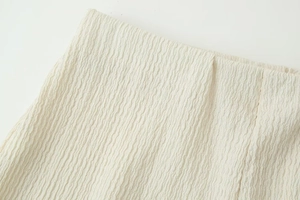 Macro shot of cream-colored fabric featuring unique 3D crinkle texture and premium feel