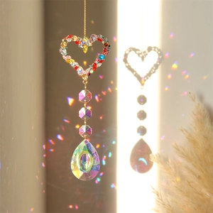 Detailed view of heart-shaped crystal suncatcher reflecting rainbow light spots