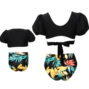 Detailed views of girls' two-piece swimsuit with puff sleeves and tropical floral print