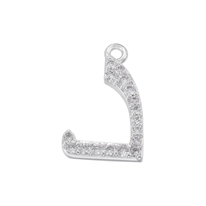 Macro shot of silver Arabic letter J pendant with sparkling pave-set cubic zirconia