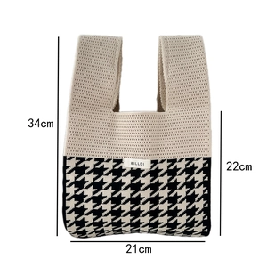 Detail view of houndstooth knit tote bag with dimension labels showing height and width