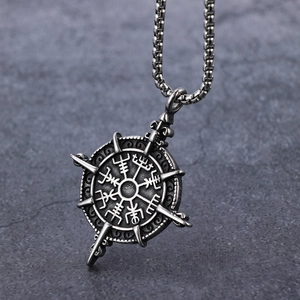 Vintage silver Viking compass pendant with Aegishjalmur symbol on a stone background