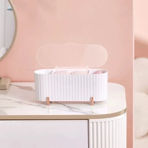 White dustproof cotton pad organizer with gold feet and ribbed texture on marble desk
