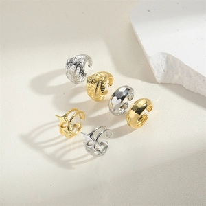 Detail of 14K gold plated rings featuring hollow mesh and geometric cross designs