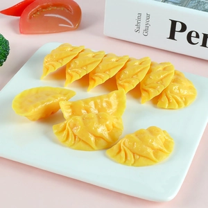 Realistic artificial yellow dumpling models set of 10 on a white plate for play food kitchen